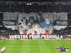 a soccer field with fans and banners on it