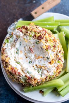 a white plate topped with green beans, celery and whipped cream covered food