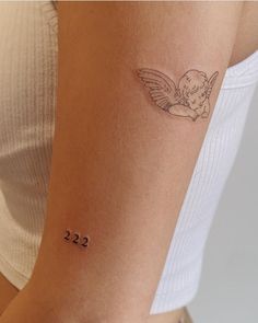 a woman with a small tattoo on her arm