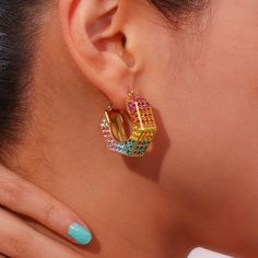 🌈 Get witchy with the Rainbow Hex Hoop Earrings! Don't underestimate the power of a rainbow hex! These retro lever back hoops are all about good trouble and colorful vibes. An adorable take on the already-cool retro chunky hoops, the inlaid gemstones bedazzle with a riot of rainbow hues, making them the perfect accessory to slay literally any fit. Embrace your inner magic and let these earrings shine! Crafted in titanium steel with 18 karat gold and clear, pink, lavender, blue, green, yellow, orange purple high-quality zircons. Lightweight and durable. Trendy Colorful Hoop Jewelry, Trendy Rainbow Hoop Earrings, Trendy Colorful Small Hoop Earrings, Trendy Small Hoop Colorful Earrings, Colorful Small Hoop Trendy Earrings, Colorful Hoop Earrings For Party, Trendy Rainbow Hoop Jewelry, Trendy Colorful Hoop Earrings For Party, Trendy Colorful Party Hoop Earrings