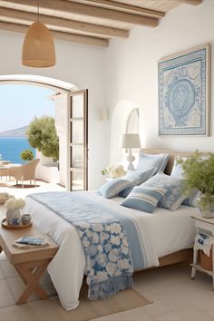 a bed with blue and white comforter in a bedroom next to an open door