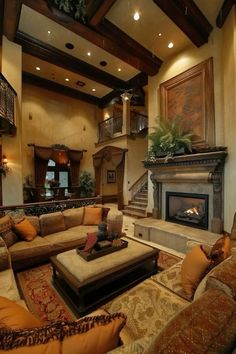 a living room filled with furniture and a fire place in the middle of it's walls