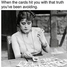 a woman sitting at a table with cards in front of her and the caption reads, when the cards hit you with that truth you've been avoiding