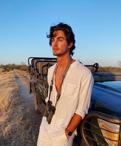 a man leaning on the back of a pick up truck