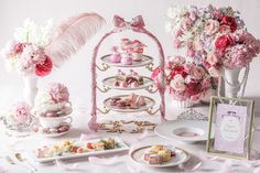 a table topped with lots of desserts and flowers