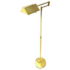 a gold colored floor lamp on a white background with the light turned on and off