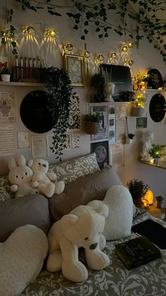 there are many stuffed animals on the bed in this room with plants and pictures above