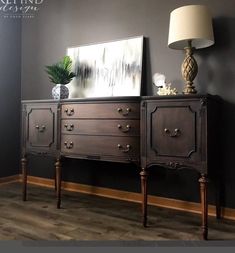 an old dresser with two drawers and a painting on the wall in a living room