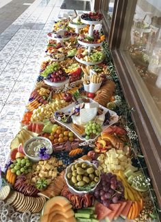 a long table filled with lots of different types of food on top of each other