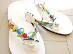 Handmade Greek leather sandals decorated with multicolor beads ,Summer sandals,White leather sandals,Beach flip flops, Everyday flat sandal This pair is made of genuine Greek leather and is decorated with acrylic beads and a suede ribbon. Elegant leather sandals, a must have accessory for the summer. They could be perfect for any woman who wants to make a difference & wear something special every day. *All sandals are made of Genuine Greek Leather! *You'll receive it in a handmade cotton bag *Th Handmade Open Toe T-strap Sandals For Spring, White Handmade Leather Sandals, Handmade White Leather Sandals, Multicolor Leather Flip Flops For Spring, Leather Multicolor Flip Flops For Spring, Handmade White Sandals For Spring, Handmade T-strap Sandals For Spring Vacation, Handmade Open Toe Flip Flops For Spring, Handmade Barefoot Sandals For Spring And Summer