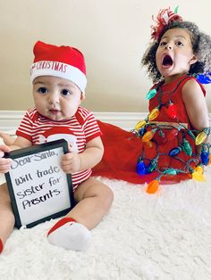 two babies dressed up as santa clause and an elf holding a sign that says god said, will trade sister for presents