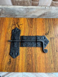 an old iron door handle on a wooden door