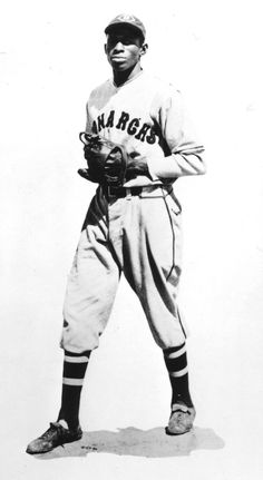 an old black and white photo of a baseball player