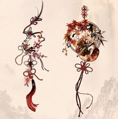 two metal ornaments hanging from the side of a wall