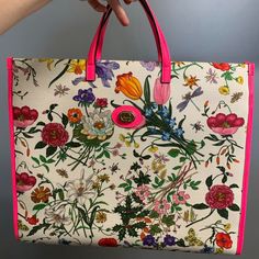 This Is A Show-Stopping Bag. Beautiful Floral Pattern And Neon Pink Accents. The Gucci Floral Canvas Tote Bag Features A Zipper Closure, And A Convenient Interior Side Pocket. This Large Size Is Ideal For Carrying A Bigger Wallet, Your Phone, Journal, And All Your Everyday Essentials. Measurements: 16" L X 5.5" W X 13.5" H Interior Pockets: One Patch Pocket Handles: Double Flat Leather Handles Handle Drop: 3.5" Closure/Opening: Single Zip Closure Interior Lining: Fine Textile Lining Hardware: Goldtone There Are Two Super Small Pen Ink Marks On The Bottom Of The Bag Which I've Included In The Photos. Otherwise, This Bag Is In Perfect Condition And Has Zero Mark Or Usage Marks On It. Gucci Floral, Small Pen, Pink Accents, Patch Pocket, Neon Pink, Leather Handle, Canvas Tote, Gucci Bag, Everyday Essentials Products