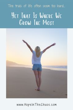 a woman standing on top of a beach next to the ocean with her arms outstretched