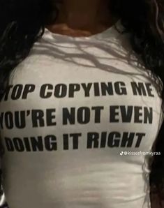 a woman wearing a t - shirt that says stop copying me you're not even doing it right