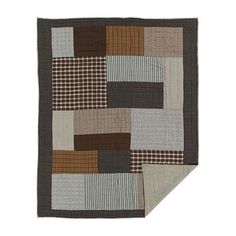 a brown and white patchwork blanket on top of a table