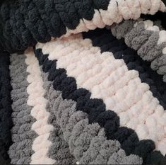 there is a crocheted blanket that looks like it has been made with yarn