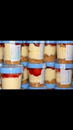 there are many desserts stacked on top of each other in plastic cups with labels