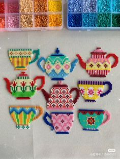 the beaded teapots and cups are all different colors, but one is made out of beads