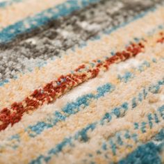 a close up view of a multi colored rug