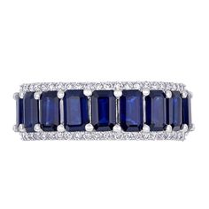 Deliver eye-catching style with this gorgeous gemstone and diamond band. Fashioned in 14K gold, this vibrant design showcases a row of 5.0 x 3.0mm emerald-cut bright blue sapphires set between the shimmering diamond-lined ribbons of the shank. Radiant with 1/4 ct. t.w. diamonds and a brilliant buffed luster, this ring is certain to become her favorite go-to look. Elegant Jewelry With Channel Set Lab-created Sapphire, Sapphire Jewelry With Channel Set Baguette Cut, Blue 14k White Gold Jewelry With Baguette Cut, Multi-stone Sapphire Baguette Cut Jewelry, Blue Emerald-cut Channel Set Jewelry, Blue Baguette Cut 14k White Gold Jewelry, Classic Channel Set Lab-created Sapphire Jewelry, Formal Sapphire Jewelry With Half Eternity Detail, Formal Sapphire Half Eternity Jewelry