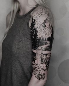 a woman with a black and white tattoo on her arm