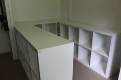 an empty room with white shelving units