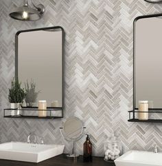 a bathroom with two sinks, mirrors and candles on the shelfs next to each other