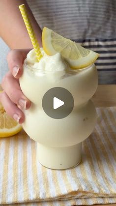 a person is holding a lemonade drink in a cup with a straw on top