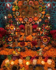 the altar is decorated with flowers, candles and skulls for dia de los muerts