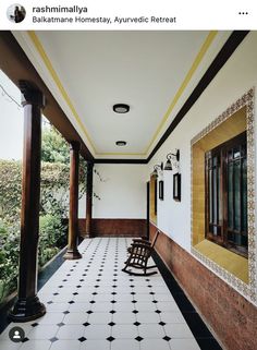 an empty porch with black and white tiles on the floor