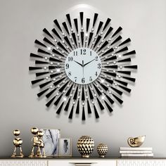 a clock that is on the side of a wall next to pictures and vases