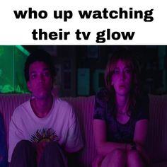 two people sitting on a couch with the caption who up watching their tv glow