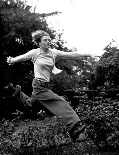 black and white photograph of a woman jumping in the air