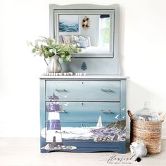 a dresser with a painting on it next to a basket