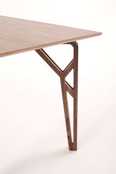 a wooden table with an unusual design on it's top and bottom edge, against a white background