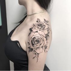 a woman with a black and white rose tattoo on her shoulder