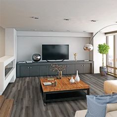 a living room filled with furniture and a flat screen tv on top of a wooden table