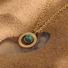 Feel the power of the sun with this exquisite Turquoise Necklace Golden Sun. Made with natural African turquoise and gold plated stainless steel, it's a piece of jewelry that is truly unique. The golden sun design is inspired by ancient Egypt and their scarab jewelry. As someone who loves to be unique, you'll definitely want to add this one-of-a-kind piece to your mystic jewelry collection.

 

 	Size: 18 inches
 	Free Shipping 2 Days
 	Authentic Green Stone: African Turquoise
 	Gold Plated Scarab Jewelry, Mystic Jewelry, Gold Sun Necklace, Mystical Jewelry, Sun Necklace, Sunflower Pendant, Golden Sun, Real Turquoise, African Turquoise