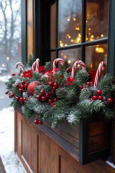 a window sill decorated with candy canes and christmas decorations