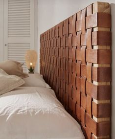 a bed with a wooden headboard made out of bricks