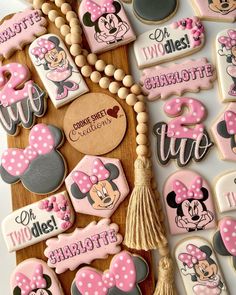 minnie mouse cookies are arranged on a board