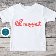 "❤ All of our items are custom designed, printed and shipped next business day from our Long Island, NY studio. Custom orders welcome! ❤  Our Onesie® and Toddler Tees are Gerber Premium Brand. ❤  Our Youth Tees are Bella Canvas   ❤ 100% natural cotton ❤ CPSIA Compliant ❤  Kid safe inks ❤ We ship next business day from NY.   ❤ USPS First Class, Priority and Express available at checkout. ❤ Delivery time is 1-4 days in the US, and approx. 6-10 days internationally. ❤ On a deadline? Upgrade to Priority Mail Express at checkout       (1-2 day delivery US; 3-5 days international). ❤ Onesie® is a registered trademark of Gerber Childrenswear LLC. ❤ For more information on CPSIA standards go to:        https://www.cpsc.gov/Regulations-Laws--Standards/Statutes/The-Consumer-Product-Safety-Improvemen Cute Cotton T-shirt With Name Print, Cute Short Sleeve Logo Print T-shirt, Cute Short Sleeve T-shirt With Logo Print, White Print Name T-shirt In Cotton, White Print Name Cotton T-shirt, White Name Print Cotton T-shirt, Unisex Name Print Crew Neck T-shirt, Unisex Crew Neck T-shirt With Name Print, White Graphic Tee With Name Print