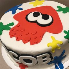 a birthday cake decorated with an owl and stars