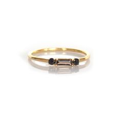 a gold ring with two black stones