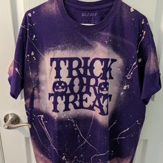 New Gildan Tee Bleached Out With Halloween Design. Trick Or Treat Tee Perfect For The Spooky Season! Size Large Casual Acid Wash Tops For Halloween, Grunge Purple Top With Screen Print, Purple Grunge Top With Screen Print, Purple Grunge Screen Printed Top, Halloween Acid Wash Crew Neck Tops, Halloween Tie Dye Crew Neck Top, Halloween Acid Wash Graphic Tee Tops, Casual Tie-dye Halloween Top, Casual Tie Dye Halloween Tops