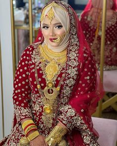 a woman in a red and gold wedding outfit