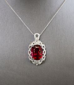 "Royal Rubellite Red Tourmaline and Diamond Necklace in 18k White Gold, 21ct Natural Red Tourmaline Statement Pendant, Luxury Jewelry Gift Welcome to true, luxury jewelry. This is perhaps our most extravagant handcrafted piece to date, featuring a natural cushion shaped rubellite tourmaline from Brazil. The stone has a red hue with hints of peachy pink depending on the viewing angle. The stone is untreated and weighs 21.02ct. We've set it securely with double claw prongs in a diamond-rich Art De Luxury Red Jewelry With Gemstone Accents, Exquisite Red Jewelry With Gemstone Accents, Formal Red Necklace With Large Pendant, Red Necklace With Large Pendant For Formal Occasions, Exquisite Red Oval Necklace, Exquisite Red Oval Necklaces, Luxury Red Oval Pendant Necklace, Luxury Ruby Oval Pendant Jewelry, Luxury Ruby Necklace With Gemstone Accents